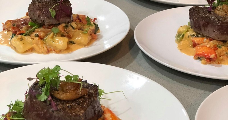 Multiple plates with a surf and turf dish