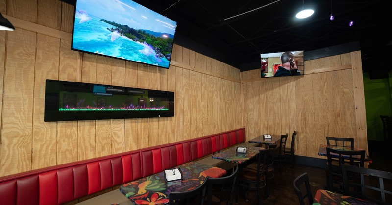 Interior, dining area with TVs on the walls