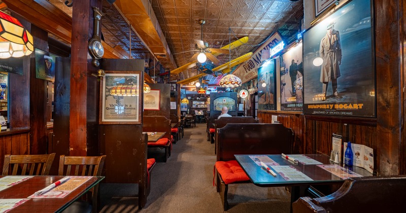 Interior featuring distinctive airplane model hanging from a ceiling and various wall decorations
