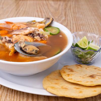 Seafood soup, with mussels, prawns, shrimp and octopus, with tortillas on the side
