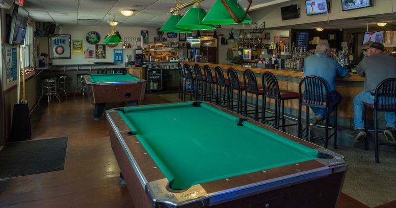Pool tables, bar behind