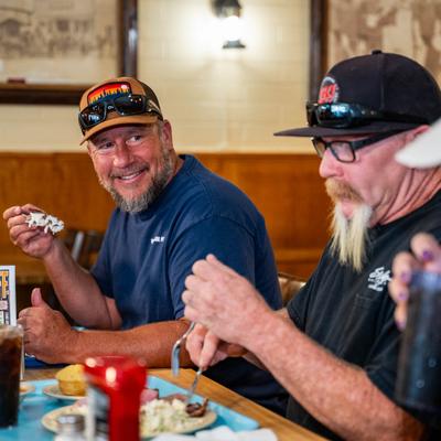 Customers enjoing food and drinks.