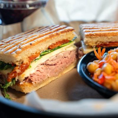 White cheddar roast beef sandwich with side carrot chickpea salad.