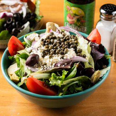 Greek salad topped with feta and capers.
