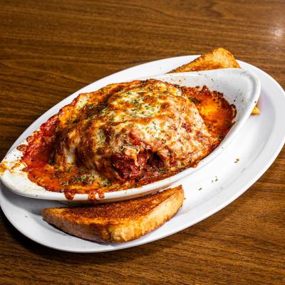 Lasagna served with toasted bread.