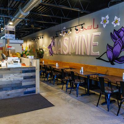 An indoor restaurant seating area features tables, chairs, and a 