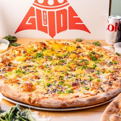 Homegrown pizza with assorted soda drinks, side dishes, and different pizza slices