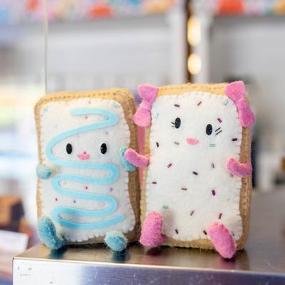 Two cute plush Pop-Tart characters sitting on a counter.