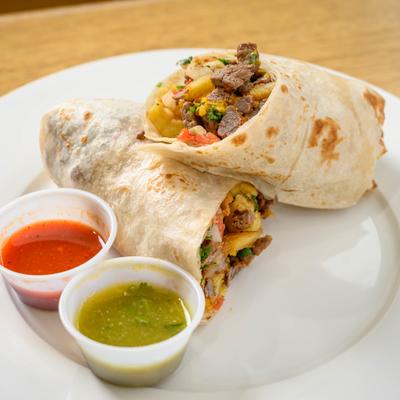 Steak burrito with veggies, served with red and green salsas.