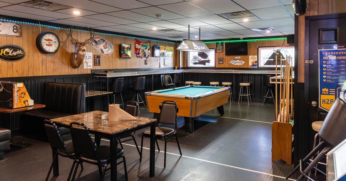 Interior, booths, tables and chairs with pool table
