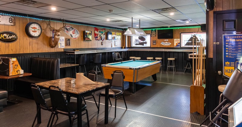 Interior, booths, tables and chairs with pool table