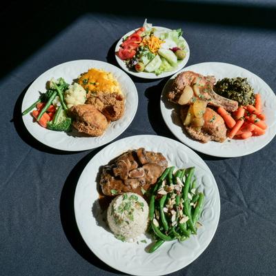 Four different dishes served on the table.