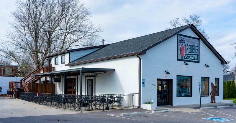 Exterior, parking view, patio with tables