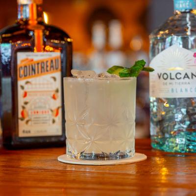 A served drink and bottles.