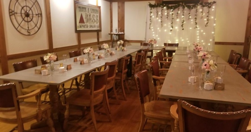 Long tables with chairs, flowers in vases