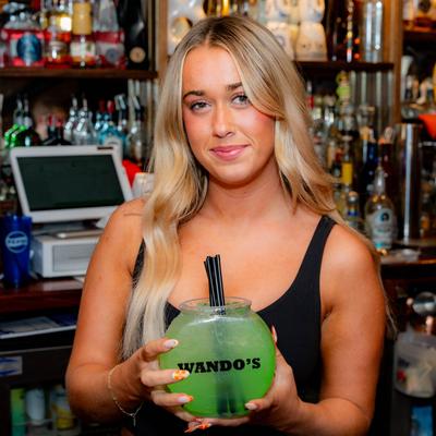 A member of the staff holding a drink.