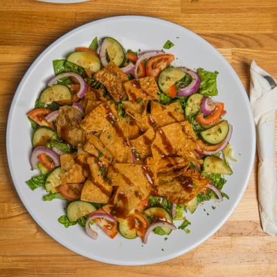 Fattoush Salad with variety of fresh vegetables topped with crispy pita chips.