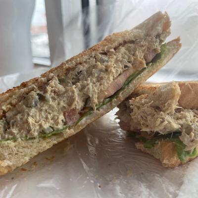 tuna fish sandwich with lettuce, tomato, and mayonnaise.