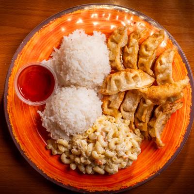 Fried dumplings with two scoops of white rice, macaroni salad, and sweet chili sauce.