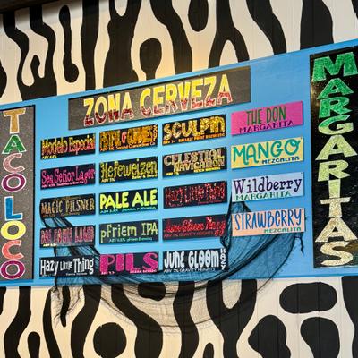 Colorful Taco Loco drink menu board.