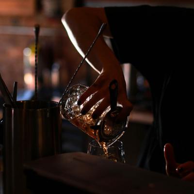 Hands serving a drink.