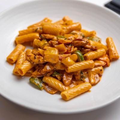 Rigatoni pasta with sausage in light tomato cream sauce.