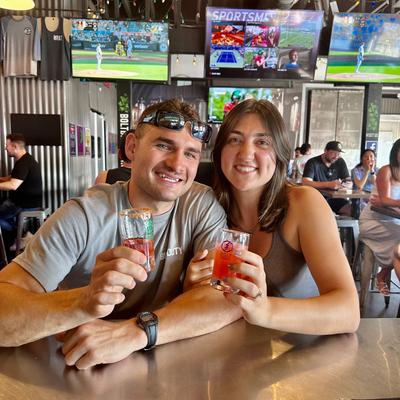 smiling couple holding drinks.