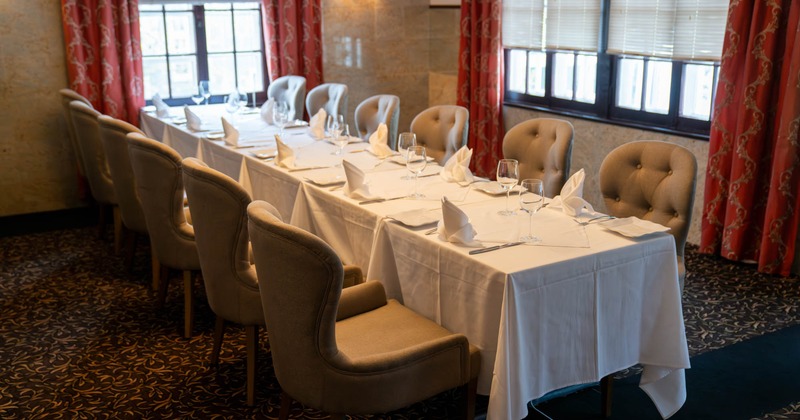 Inside, long dining table, chairs, tableware