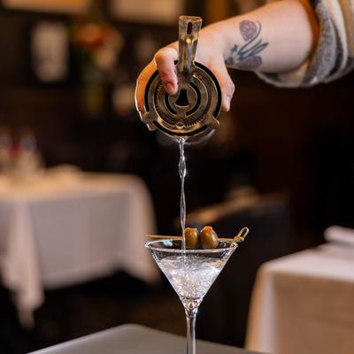 A hand pouring a drink.