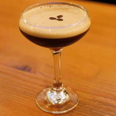 Espresso Martini in a coupe glass, garnished with three coffee beans.