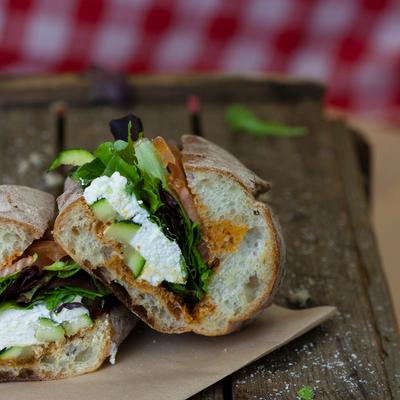 Fresh Mozzarella sandwich with roasted red peppers, greens and tomatoes.