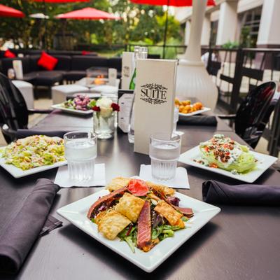 Patio tables with served dishes, outdoor dining, patio seating.