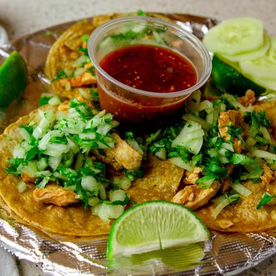 Enchiladas, with scallops, shrimp, crabmeat, sauce, onions, and cilantro.