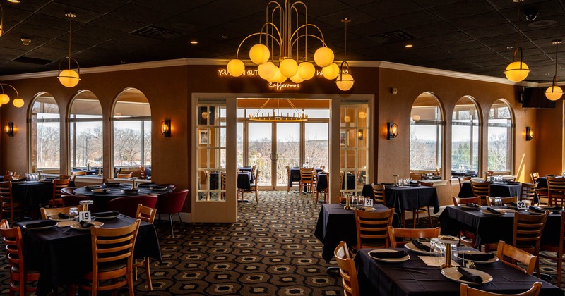 Interior, large separated open space dining areas, large folding doors, vintage chandeliers