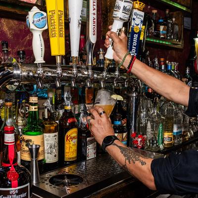 A bartender pouring tap beer.