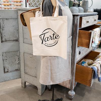 Shopping bag hanging from a mannequin.