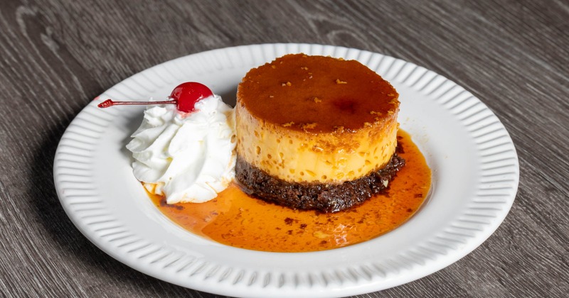 Choco Flan served with caramel sauce and whipped cream