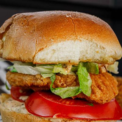 Burger with lettuce and tomatoes.