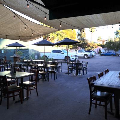 Brewhouse back patio with sun sails ,  lights and table and chairs.
