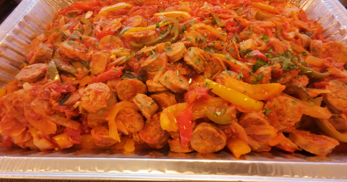 Sausage and peppers with sauce in a catering tray
