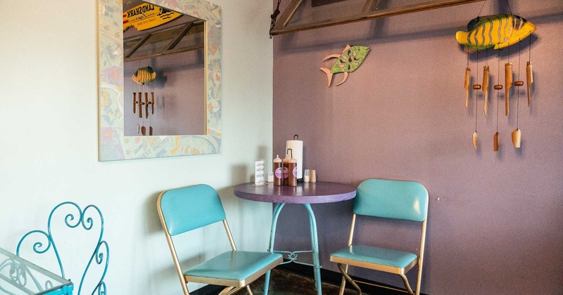 A table and two chairs in a nicely decorated corner of the restaurant