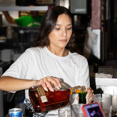 A staff member pouring a drink.