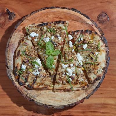 Grilled flatbread with sheep cheese, garlic, mint, herbs, and spices.