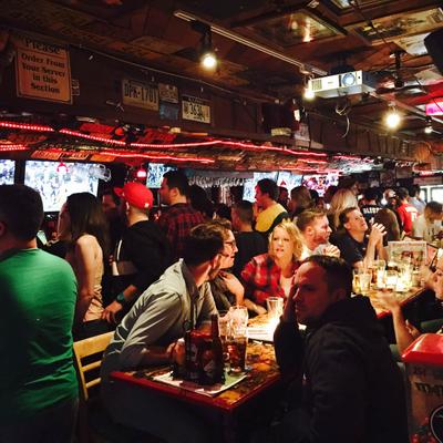 Customers dining at table in busy bar