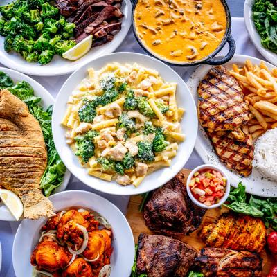 Assortment of food plates on a table, top down view.