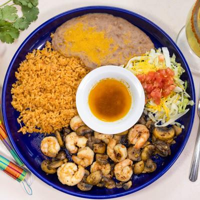 Shrimp plate with rice, beans, mushrooms, salad, and dipping sauce.