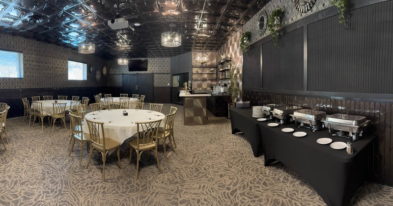 Interior, dining and banquette area, catering trays on a separate table, bar in the back