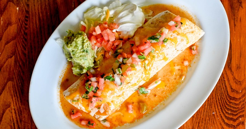 Chimichanga with guacamole, tomato and whipped cream