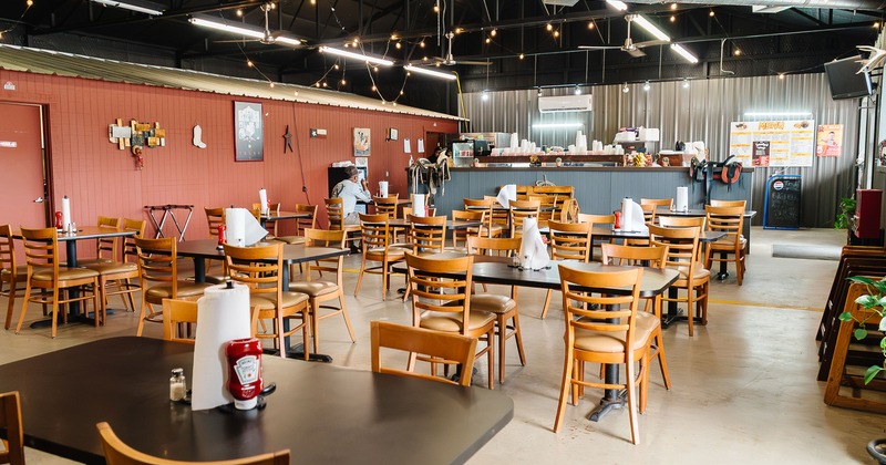 Spacious and cozy interior dining area with tables ready for guests