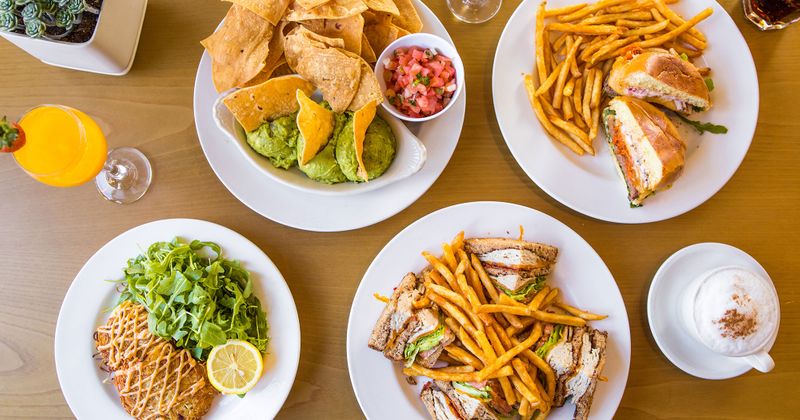 Group of food: Guacamole, Chips ,Crabcakes, Cottage, Club Sandwich, Grass Fed Burger